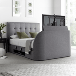 An ottoman bed frame with a grey upholstered headboard and an enclosed Tv space, featuring storage space beneath.